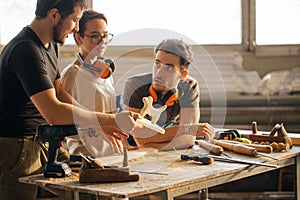 Carpenter Training Female Apprentice To Use Plane