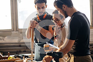 Carpenter Training Female Apprentice To Use Plane