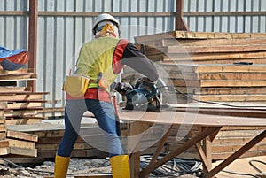 Carpenter using circular saw at the construction site
