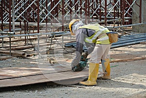 Carpenter using circular saw at the construction site