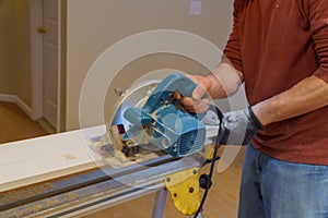 Carpenter using circular saw for cutting boards with hand power tools