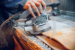 Carpenter using circular saw for cutting wooden boards.