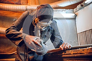 Carpenter using circular saw for cutting wooden boards.