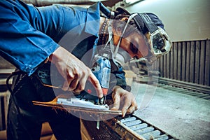 Carpenter using circular saw for cutting wooden boards.