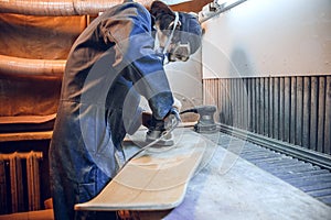 Carpenter using circular saw for cutting wooden boards.