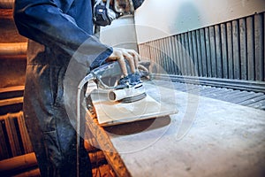 Carpenter using circular saw for cutting wooden boards.