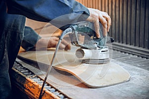 Carpenter using circular saw for cutting wooden boards.