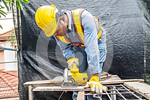 Carpenter using circular saw for cutting wooden boards with power tools, construction and home renovation, repair and construction