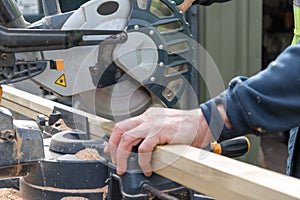 Carpenter using circular saw in DIY project.