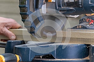 Carpenter using circular saw in DIY project.