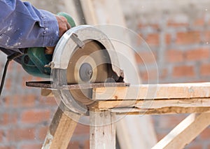 Carpenter using circular saw in loggers
