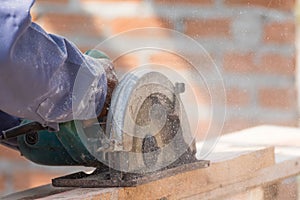 Carpenter using circular saw in loggers