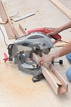 Carpenter using circular saw for wood