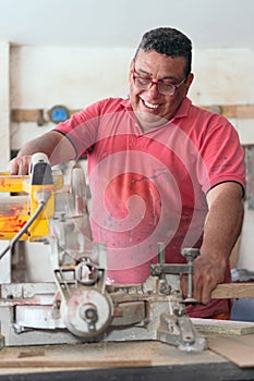 Carpenter using a circular saw in the workshop