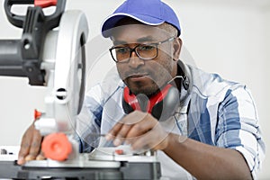 carpenter using circular saw in workshop