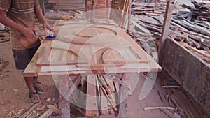 Carpenter using an electric sander on a wooden surface in a workshop wood polish at workshop