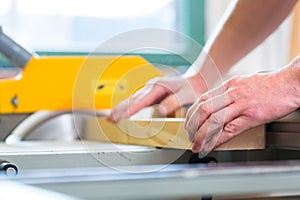 Carpenter using electric saw in carpentry