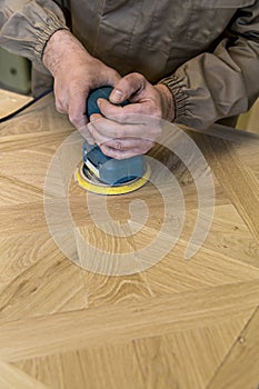 Carpenter using grinder on wood