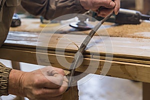 Carpenter using grinder on wood