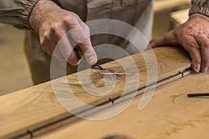 Carpenter using grinder on wood