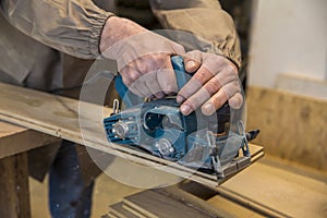 Carpenter using grinder on wood