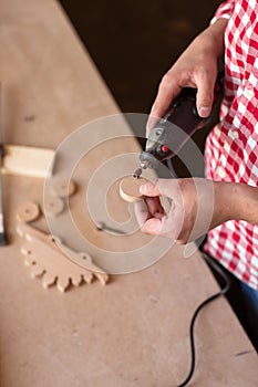 Carpenter Using a high speed rotary multi tool to cut a wooden