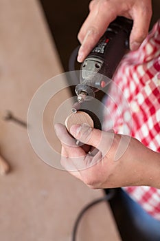Carpenter Using a high speed rotary multi tool to cut a wooden
