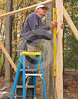 Carpenter using a level