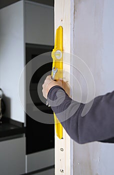 Carpenter using the level tool