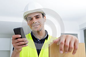 carpenter using mobile phone on site