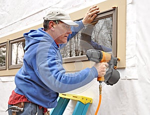 Carpenter using nail gun