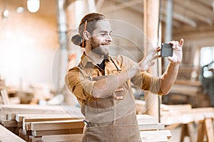 Carpenter using phone in the workshop