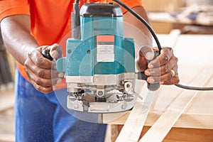 Carpenter using a router