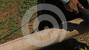 Carpenter using a sander to smooth a wooden log