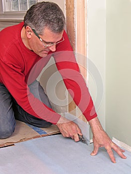 Carpenter using utility knife