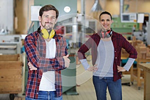 carpenter woman and man with drill in workshop