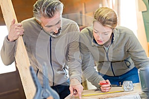 carpenter woman and man in workshop