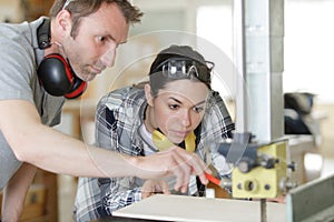 carpenter woman and man in workshop