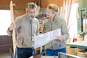 carpenter woman and man in workshop