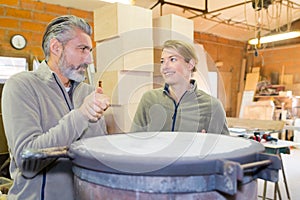 carpenter woman and man in workshop