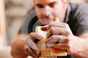 Carpenter with wood planer