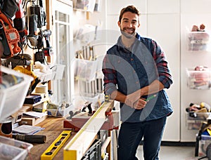 Carpenter, wood and portrait of man in workshop for home development, diy tools and building renovation. Smiling, male