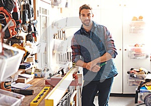 Carpenter, woodwork and portrait of man in workshop for home development, diy tools and building renovation. Smiling