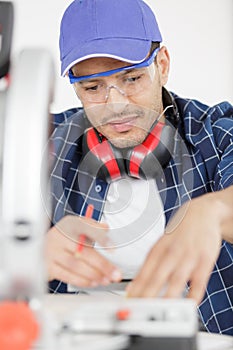 carpenter work with circular saw for cutting boards