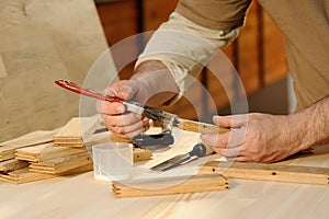 Carpenter at work gluing piece of wood photo