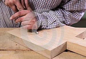 Carpenter at work. Hands cutting oak board with chisel