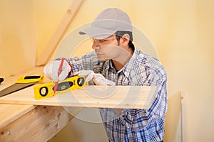 Carpenter at work using a bubble level