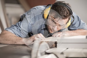 Carpenter at work with wood