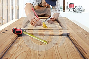 Carpenter work the wood, measuring a wooden vintage door