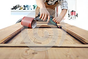 Carpenter work the wood with the rotary tool